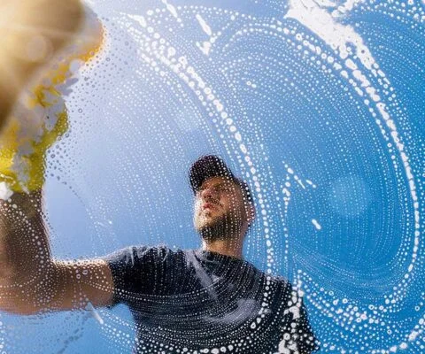 Next Pane professional window cleaning technician washing window glass with pure water in Tennessee
